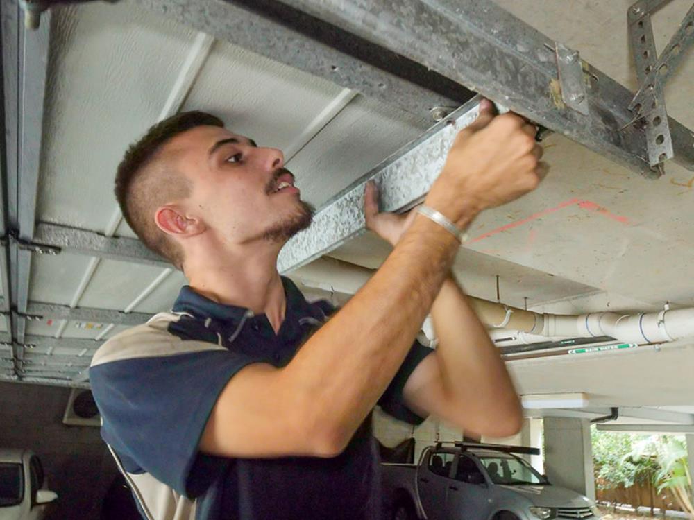 River City Doors technician performing garage door repairs on Gold Coast